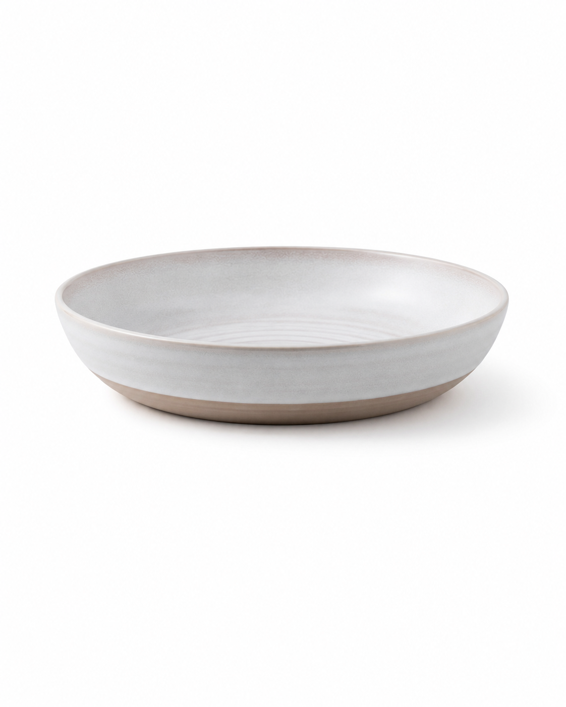 Side view of handmade white reactive glaze ceramic pasta bowl with a wide shallow profile and natural clay base Main image