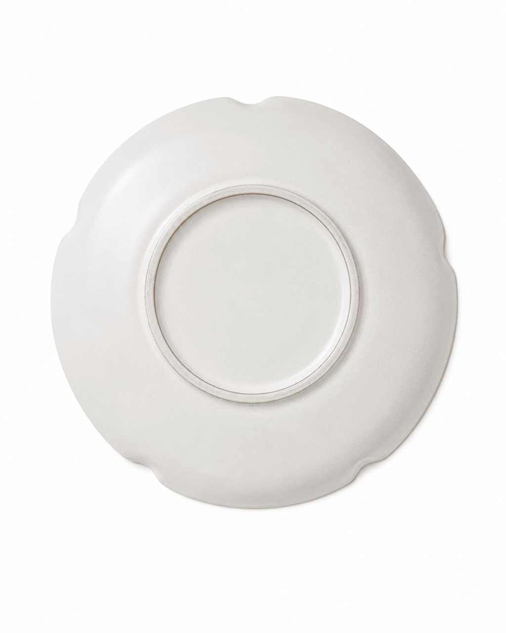 Bottom view of handmade white scalloped ceramic dinner plate with circular foot ring