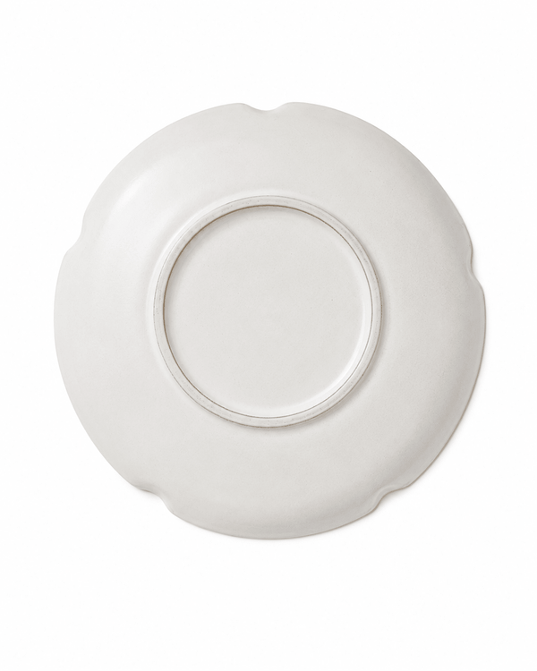 Bottom view of handmade white scalloped ceramic dinner plate with circular foot ring