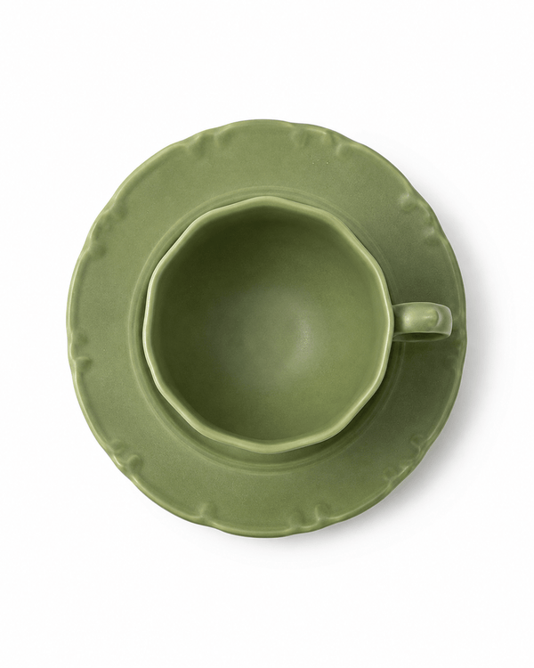 Top view of olive green ceramic coffee cup and matching scalloped saucer