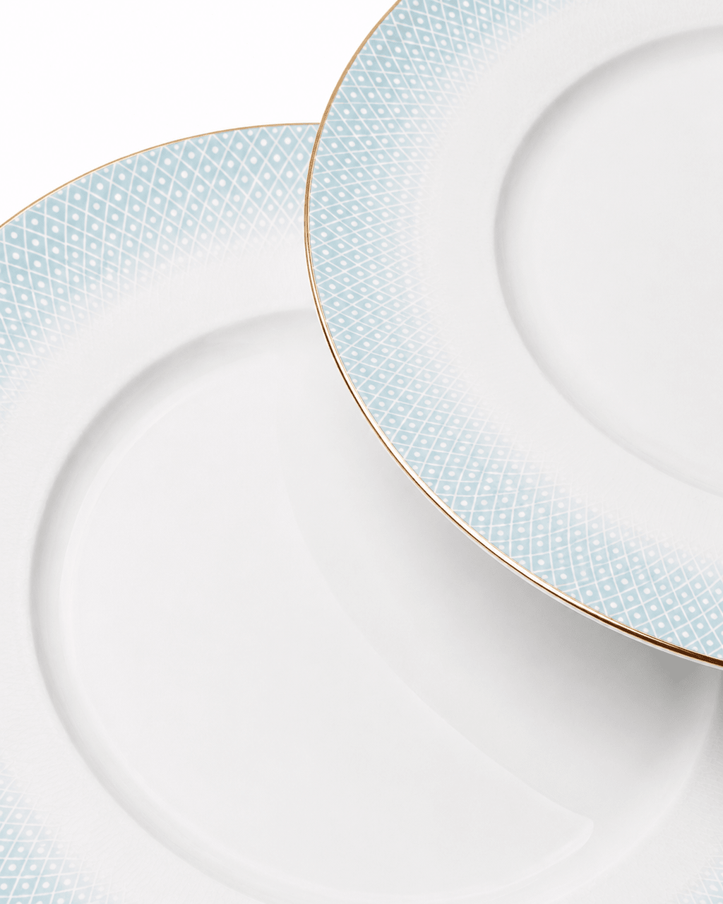 Close-up of white fine bone china plates with subtle textured rim pattern