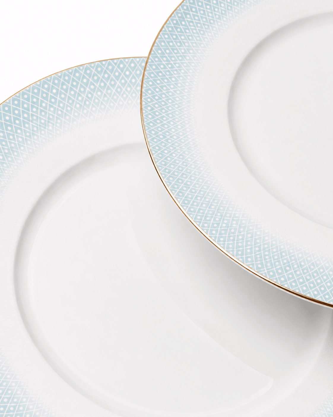 Close-up of white fine bone china plates with subtle textured rim pattern