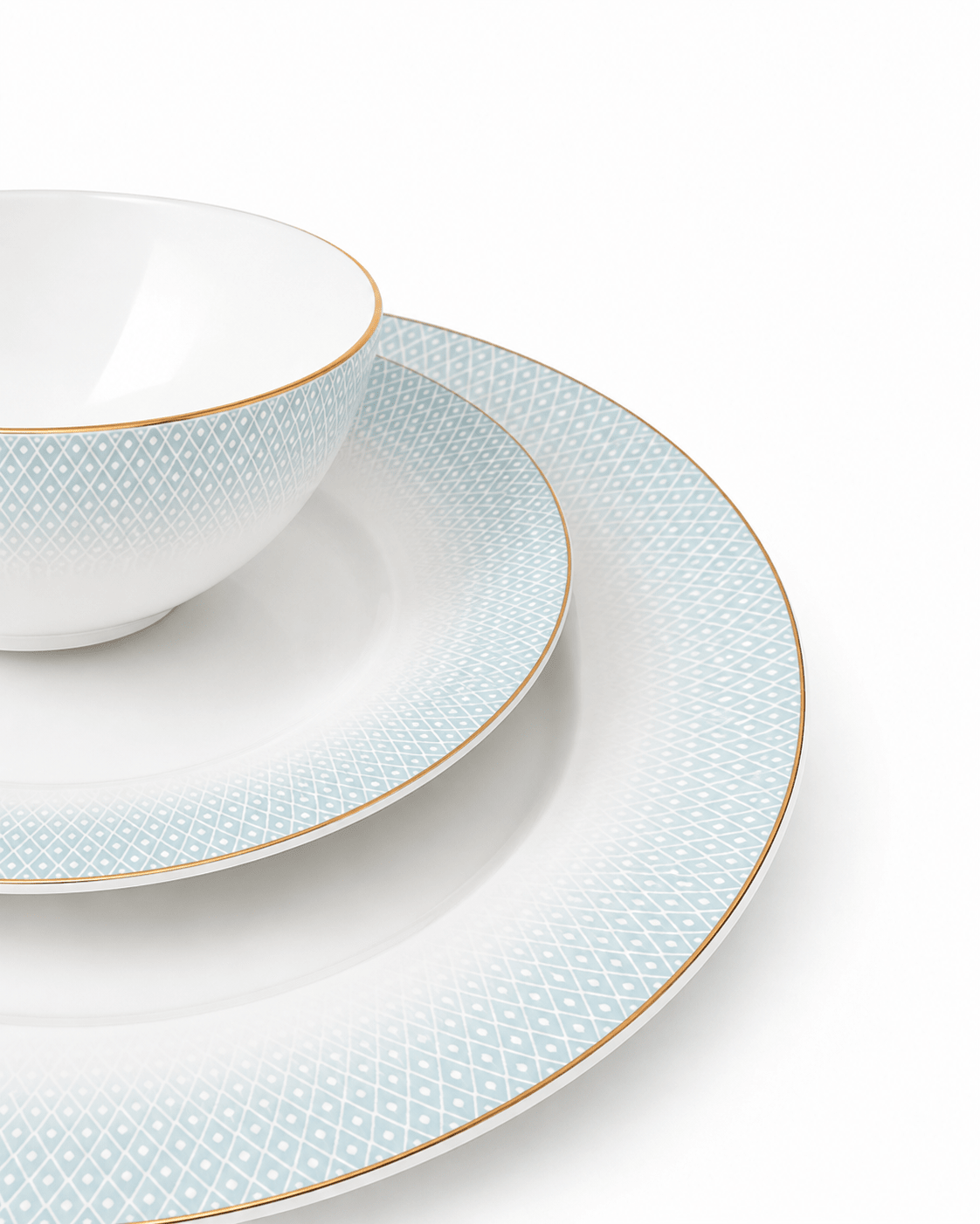 Close-up of white textured bone china bowl, side plate and dinner plate
