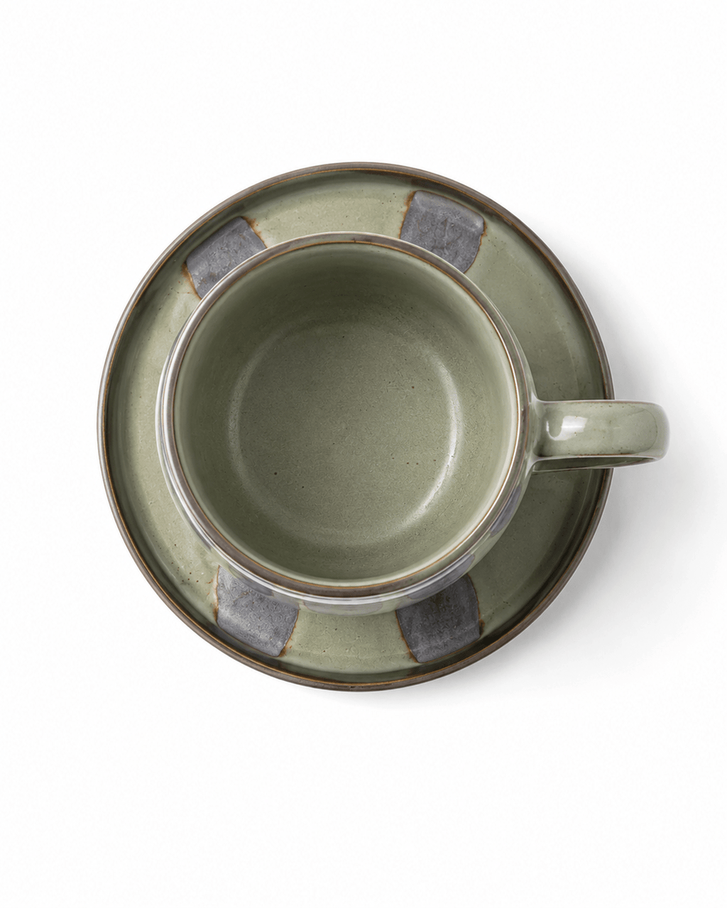 Top view of sage green ceramic coffee cup and matching saucer with grey glaze details
