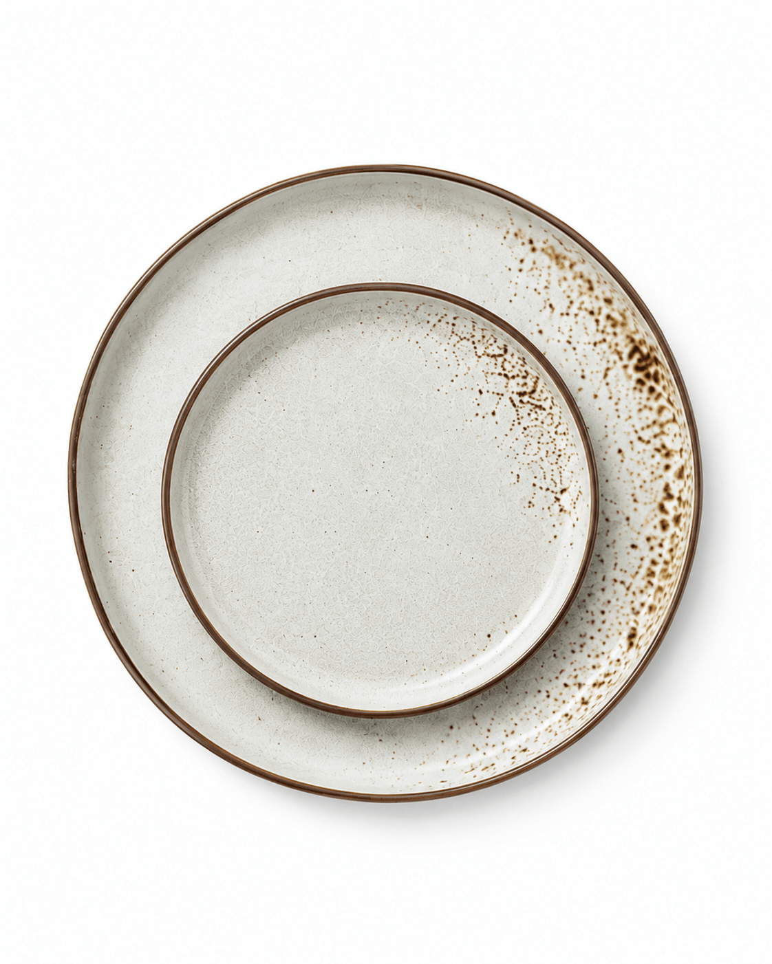 Top view of matching speckled ceramic dinner and side plates with brown rims and reactive glaze detailing