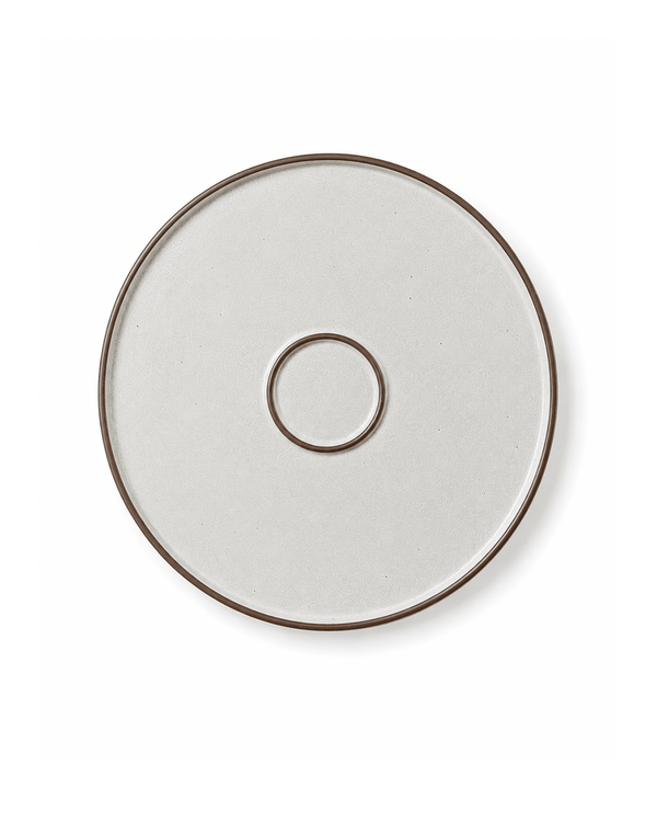 Bottom view of a speckled ceramic side plate with brown rim and circular foot ring
