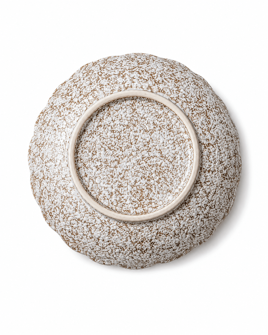 Bottom view of handmade speckled ceramic serving bowl showing the circular foot ring and reactive glaze finish