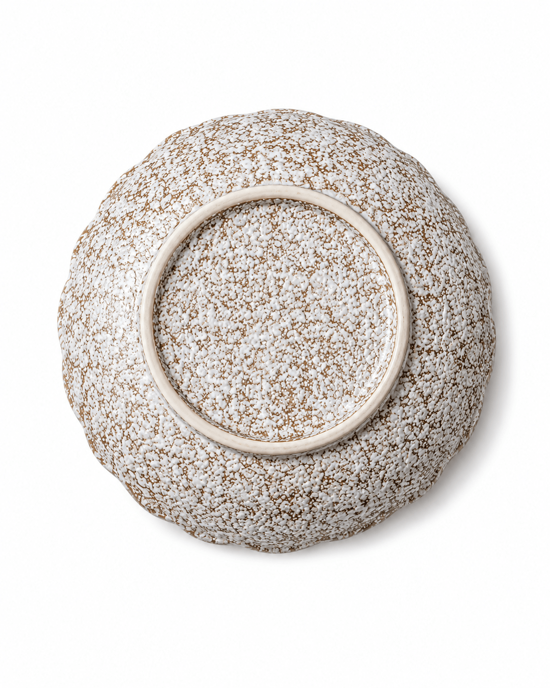 Bottom view of handmade speckled ceramic serving bowl showing the circular foot ring and reactive glaze finish