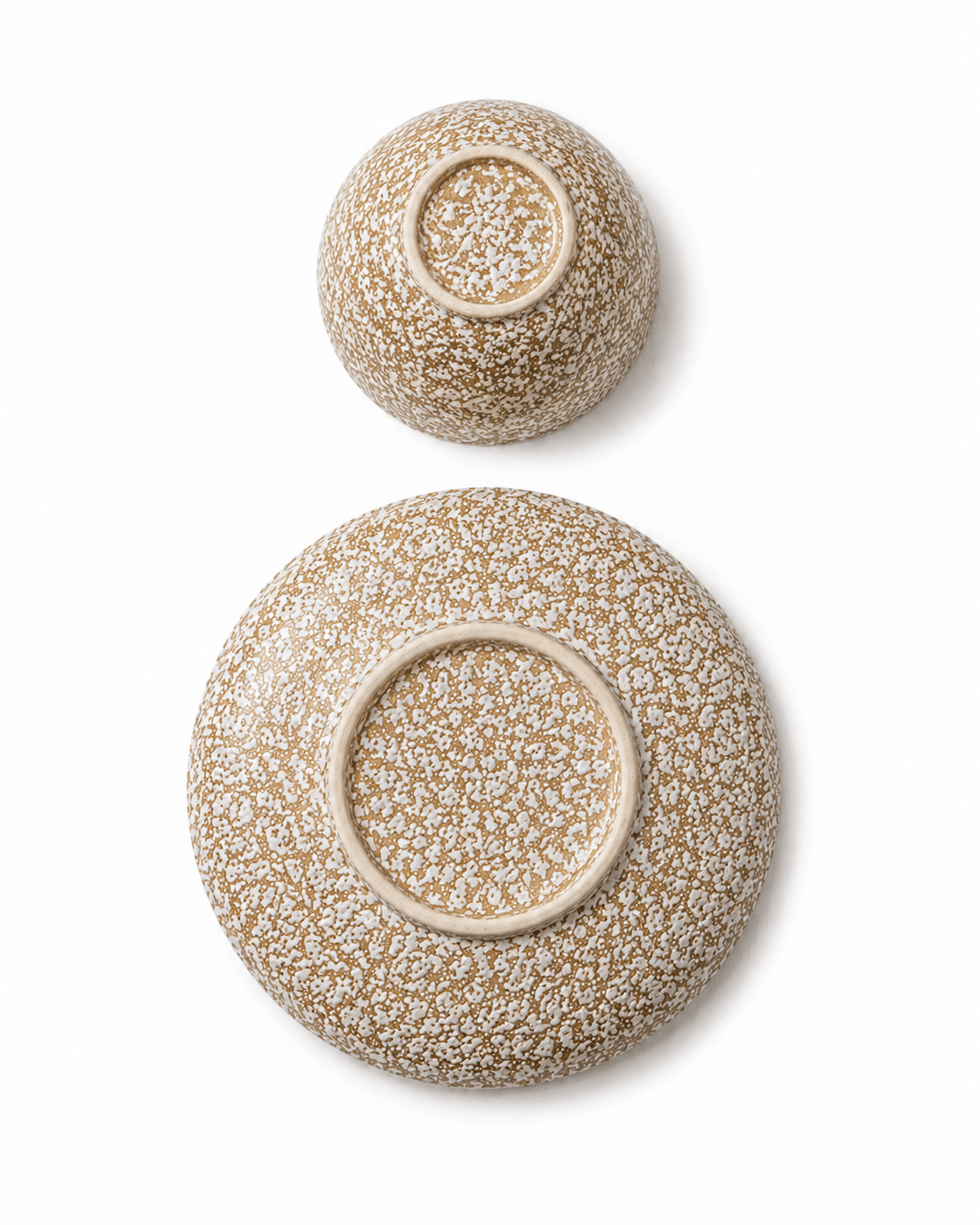 Speckled stoneware bowl and side plate bottom view showing handmade ceramic foot rings
