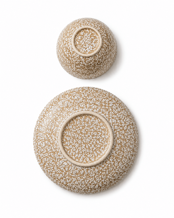 Speckled stoneware bowl and side plate bottom view showing handmade ceramic foot rings