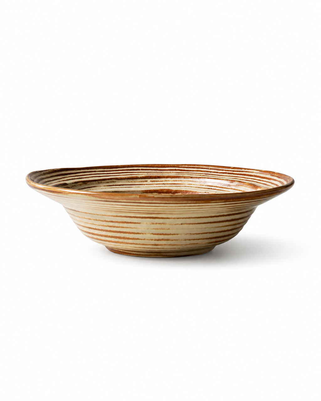 Side view of beige and brown striped reactive glaze ceramic pasta bowl with wide flared rim and shallow handmade profile