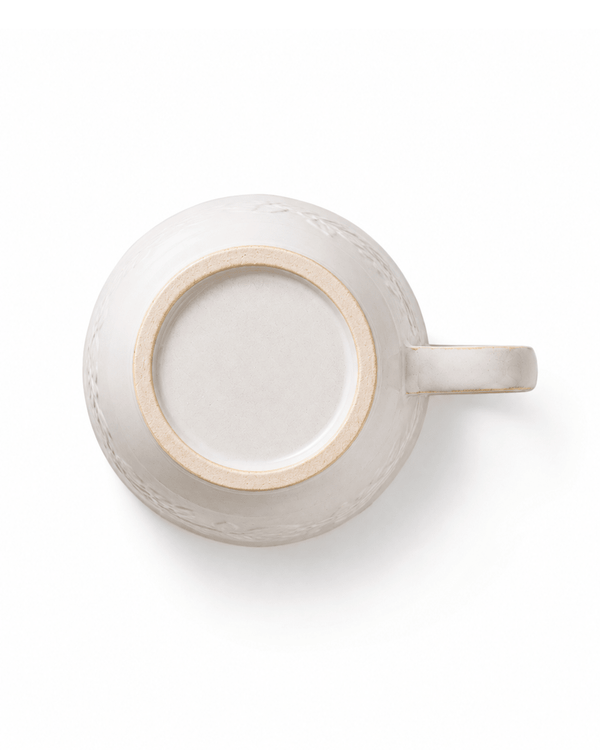 Bottom view of white handmade ceramic coffee cup showing the natural unglazed foot ring and handcrafted finish