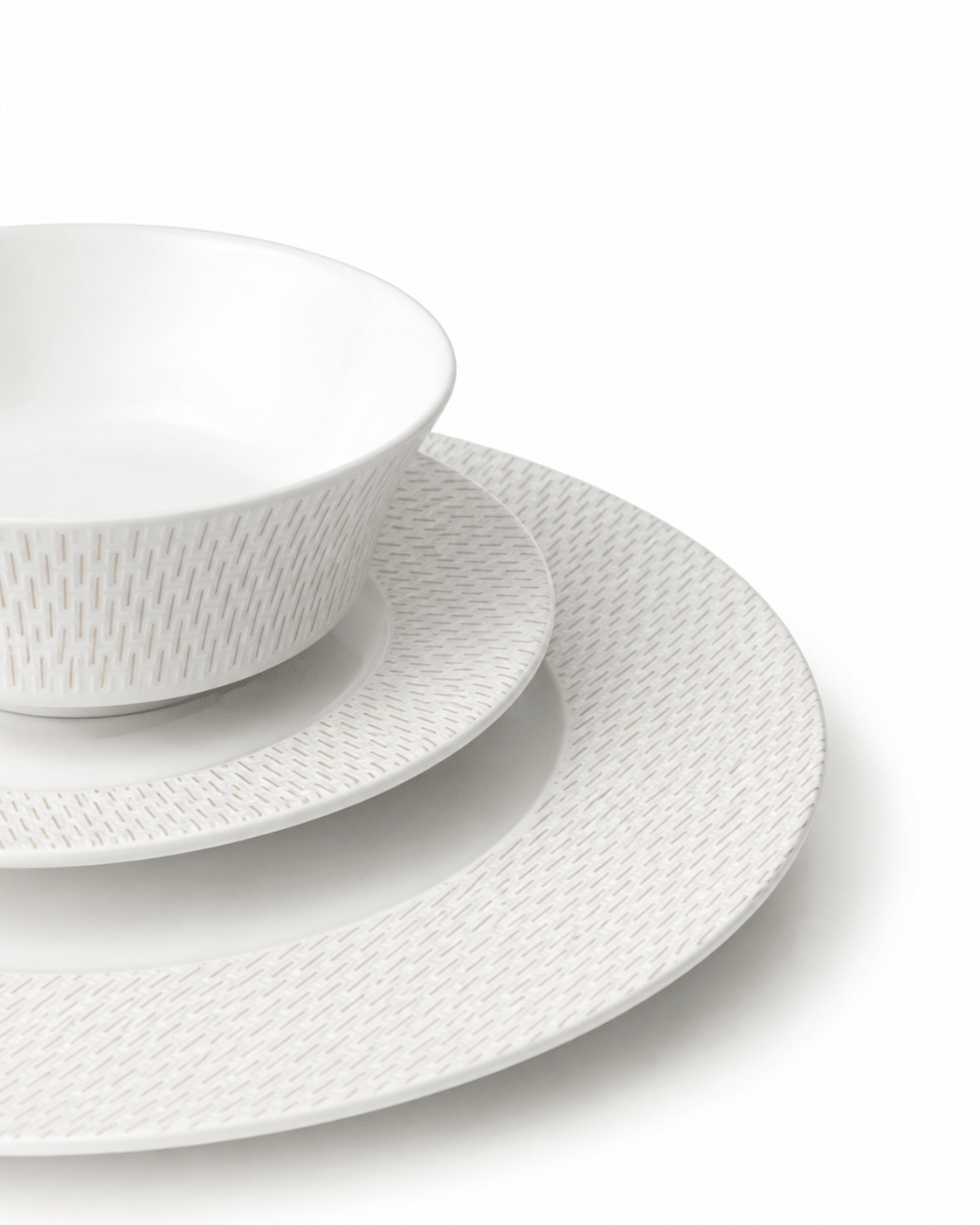 Close-up of white textured bone china bowl, side plate and dinner plate