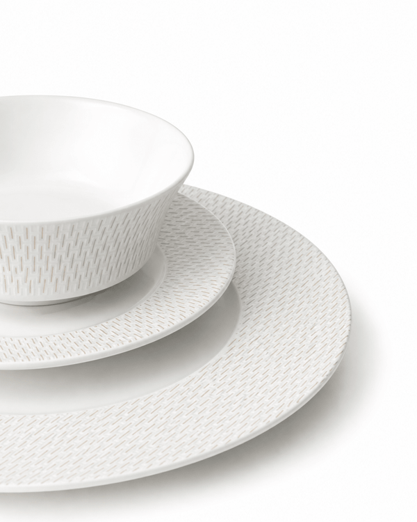 Close-up of white textured bone china bowl, side plate and dinner plate