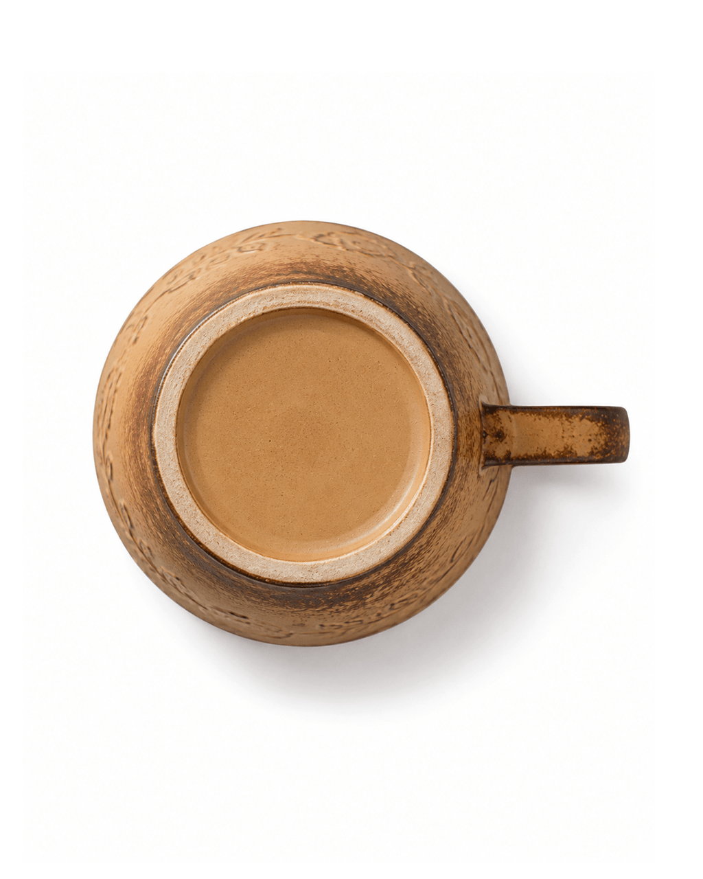 ottom view of rustic yellow handmade ceramic coffee cup showing the natural foot ring and textured glaze finish